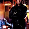"Original 1997 Batman Forever theatrical poster hand-signed by Chris O'Donnell in silver ink; actor in black leather jacket posed against illuminated city street backdrop—offset-lithograph, vibrant color palette, 1990s superhero cinema promotional art"