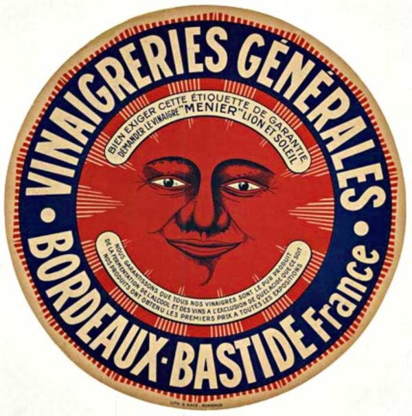 Vintage circular lithograph advertisement for French vinegar (Vinaigeries Générales) featuring a bold red sun face with serene, smiling expression centered against cream ground. Cobalt blue text arcs around the outer ring stating "VINAIGERIES GENERALES BORDEAUX BASTIDE FRANCE." Decorative golden-brown borders frame the design. Rich color saturation with striking chromatic contrast. Original lithograph, linen-backed. Circular format poster.