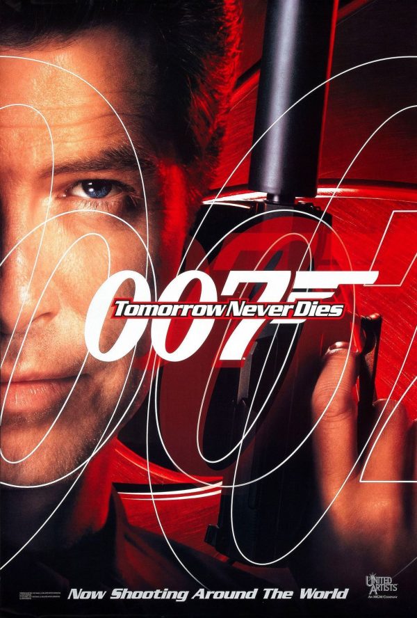 Original 1997 James Bond poster for “Tomorrow Never Dies” showing Pierce Brosnan in a dramatic close-up design with bold 007 typography, red and black color scheme, and the film title at center.