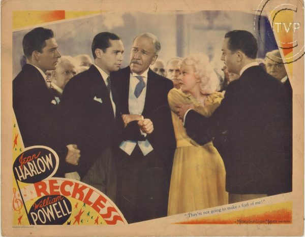 Original 11 x 14" lobby card for Reckless, featuring Jean Harlow and William Powell in a studio-era ensemble scene with period formal attire, star-focused composition, and classic photographic artwork.