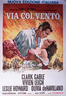 Circa 1950s Italian grande poster for Gone with the Wind (Via col vento), artist unknown, featuring Clark Gable holding Vivien Leigh in a dramatic embrace against a fiery sky with Civil War scenes below.