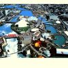 Mike Roberts original 1974 aerial photograph lithograph of Expo '74 World's Fair, Spokane, Washington; vibrant bird's-eye view showing fairgrounds, water features, and exhibition pavilions—photo lithography, bold mid-century color palette, World's Fair documentation photography